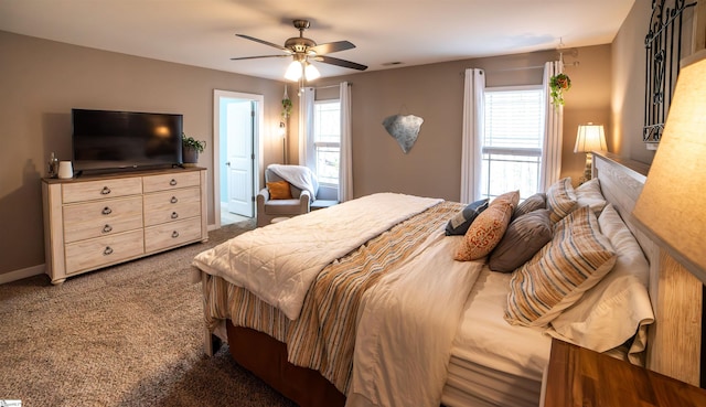 carpeted bedroom featuring baseboards and ceiling fan