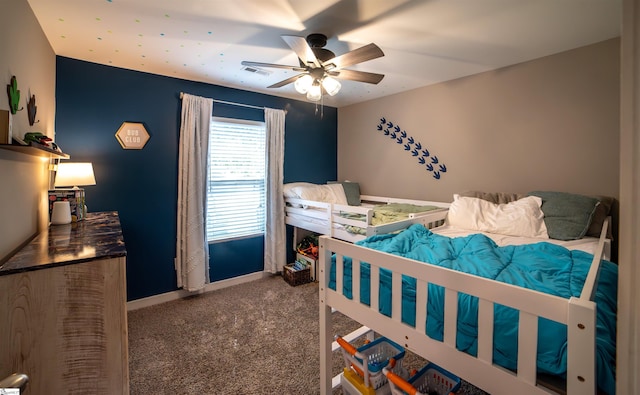 carpeted bedroom with visible vents, baseboards, and ceiling fan