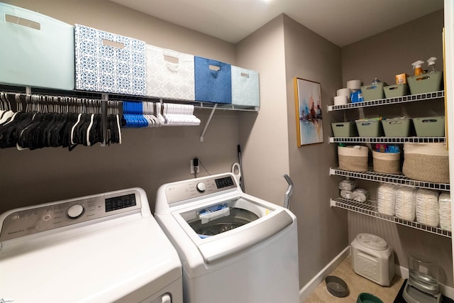 laundry area featuring laundry area, baseboards, independent washer and dryer, and tile patterned floors