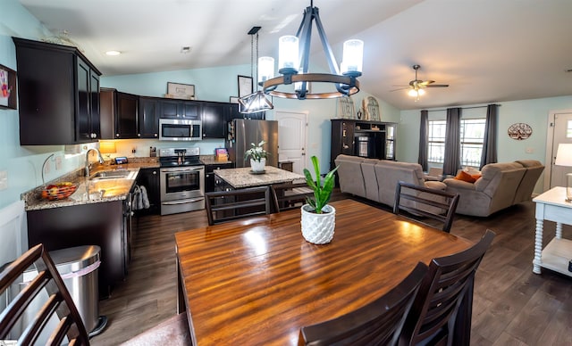 dining space featuring a ceiling fan, lofted ceiling, and dark wood-style floors