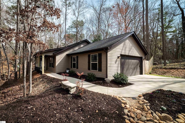 view of home's exterior featuring an attached garage and concrete driveway