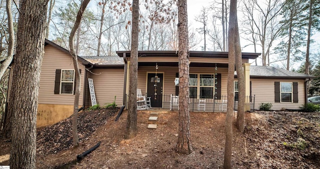 single story home featuring a porch and a shingled roof