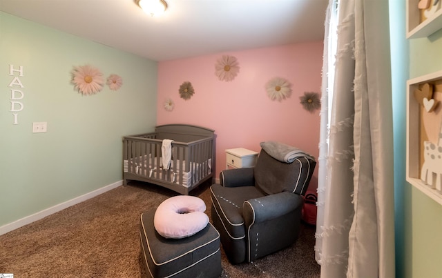 bedroom featuring baseboards, a nursery area, and carpet flooring