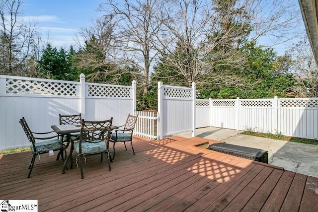 wooden deck featuring outdoor dining area and fence