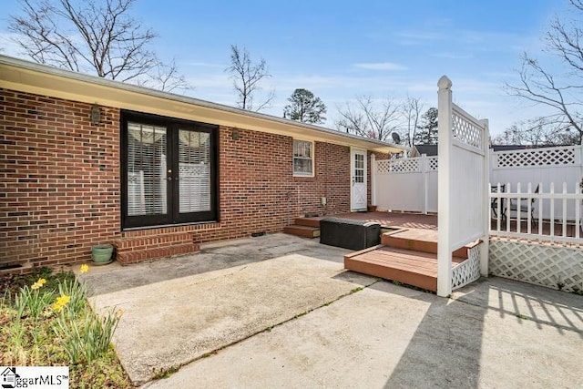 view of patio / terrace featuring a deck and fence