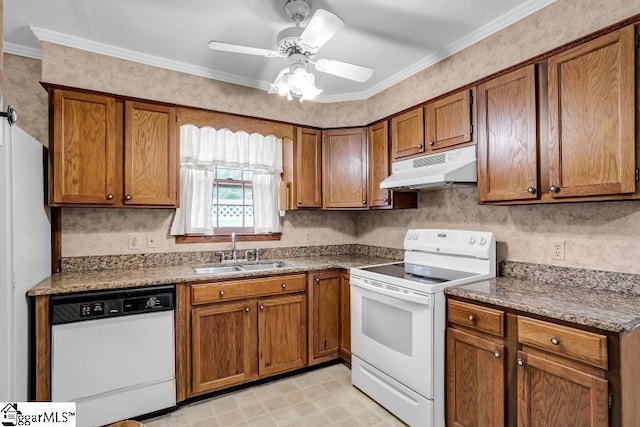 kitchen with under cabinet range hood, white appliances, brown cabinetry, and a sink