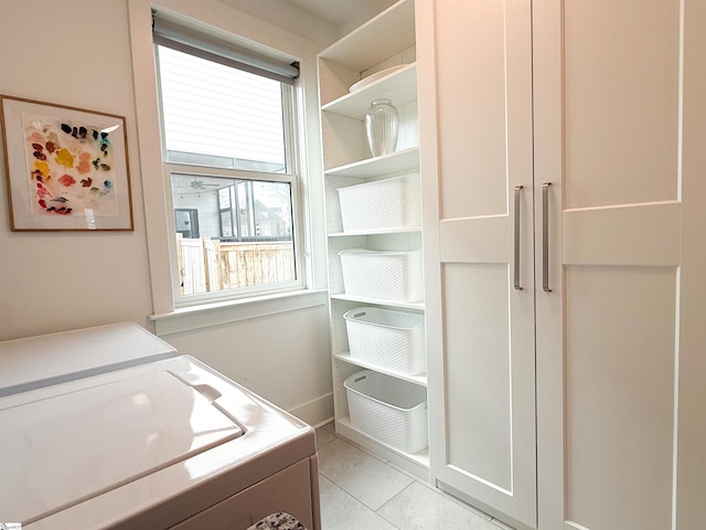 laundry area with light tile patterned flooring, laundry area, independent washer and dryer, and plenty of natural light