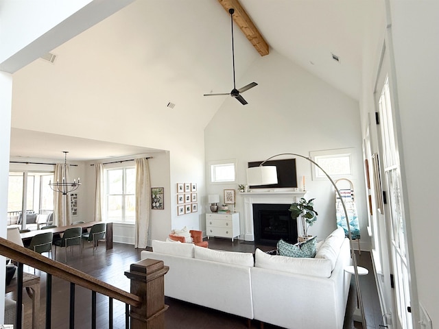 living area featuring beamed ceiling, a fireplace, dark wood-style flooring, and high vaulted ceiling