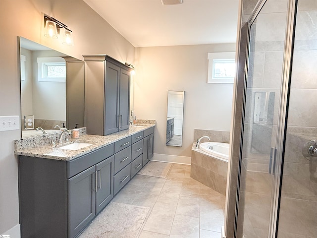 bathroom with plenty of natural light, a stall shower, and a sink