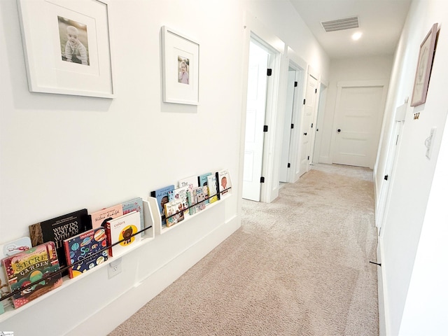 corridor with visible vents and light carpet