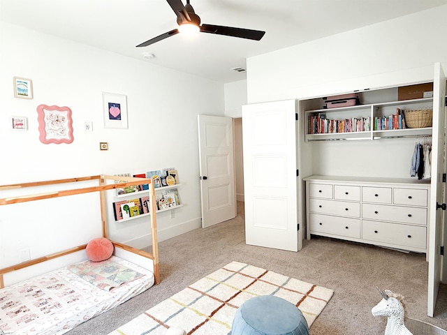 bedroom featuring visible vents, light colored carpet, baseboards, and ceiling fan