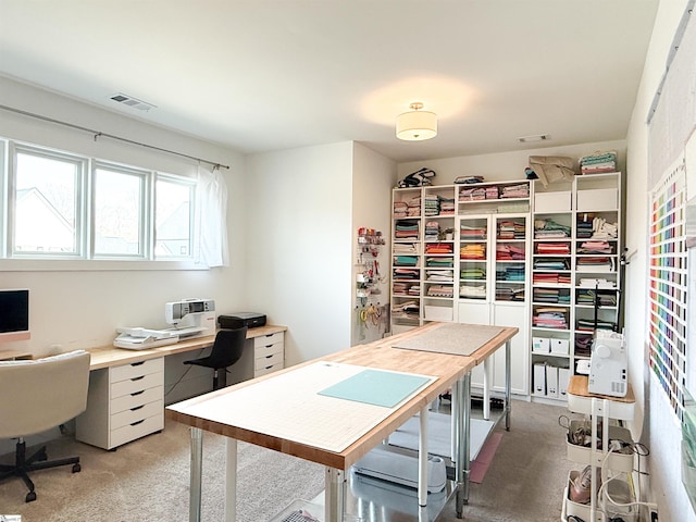 office area featuring visible vents and light carpet