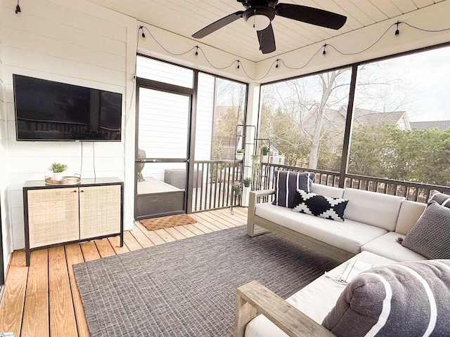 sunroom / solarium with wood ceiling and a ceiling fan