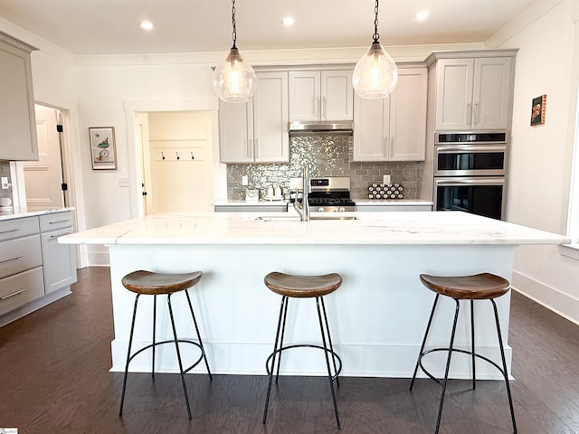 kitchen featuring stainless steel appliances, gray cabinets, and decorative backsplash