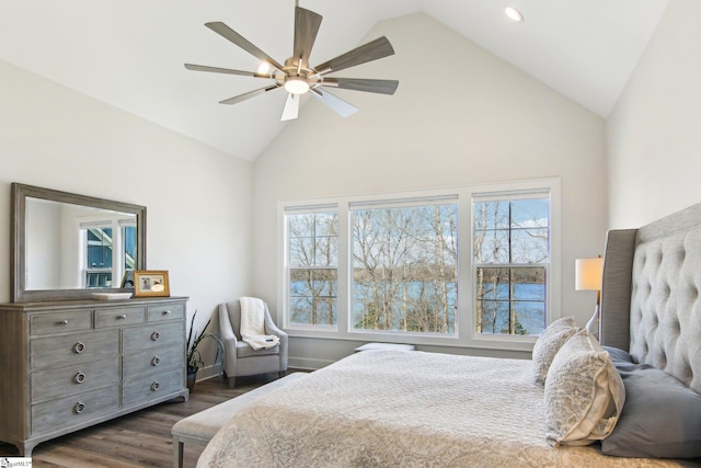 bedroom featuring ceiling fan, multiple windows, dark wood-style floors, and high vaulted ceiling