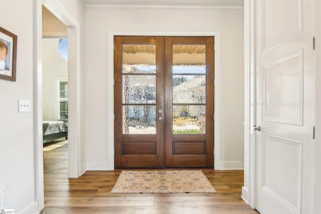 entrance foyer with light wood-style floors and baseboards