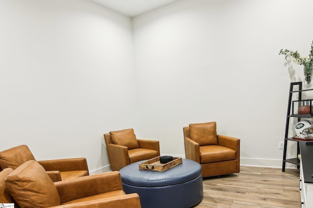 sitting room featuring light wood-style flooring and baseboards