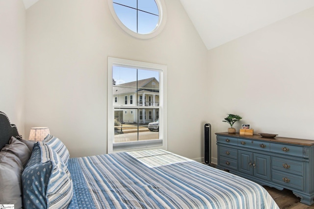 bedroom featuring dark wood-style floors and high vaulted ceiling