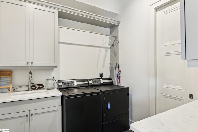 laundry area featuring a sink, cabinet space, and washer and dryer