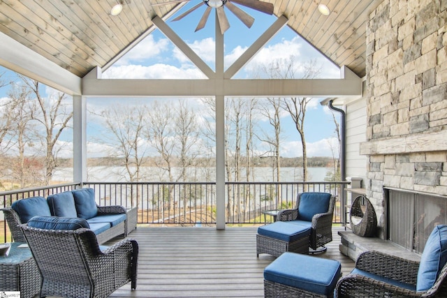 wooden terrace featuring an outdoor living space, a water view, and ceiling fan