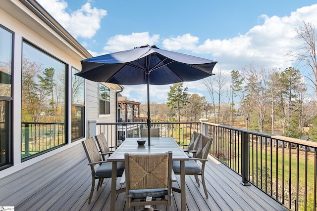 wooden deck featuring outdoor dining space