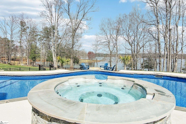 view of swimming pool with a patio area, a fenced in pool, an in ground hot tub, and fence