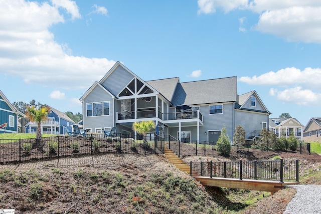 back of house featuring stairway, a residential view, and fence