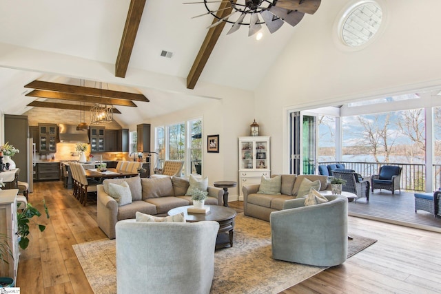 living room featuring hardwood / wood-style flooring, plenty of natural light, a ceiling fan, and visible vents