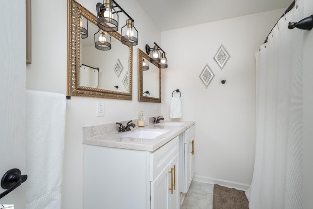 bathroom featuring double vanity, tile patterned flooring, baseboards, and a sink