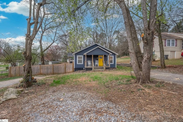 bungalow-style house with fence