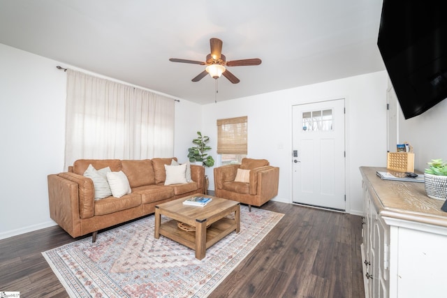 living room featuring baseboards, dark wood-style flooring, and a ceiling fan