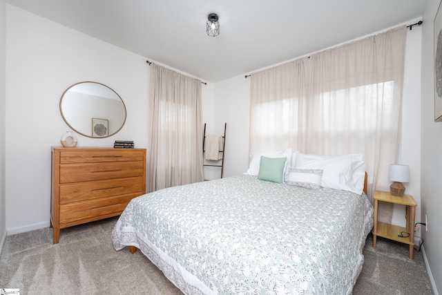 bedroom featuring carpet flooring and baseboards