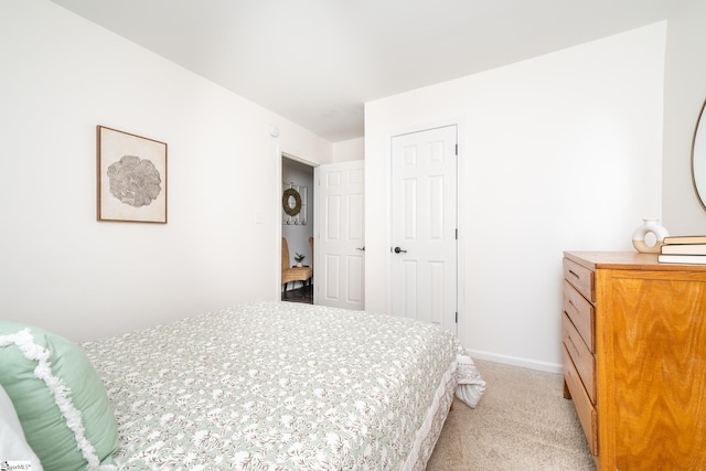 bedroom featuring baseboards and light carpet