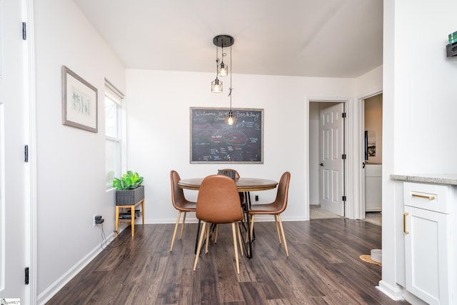 dining area with baseboards and dark wood-style flooring