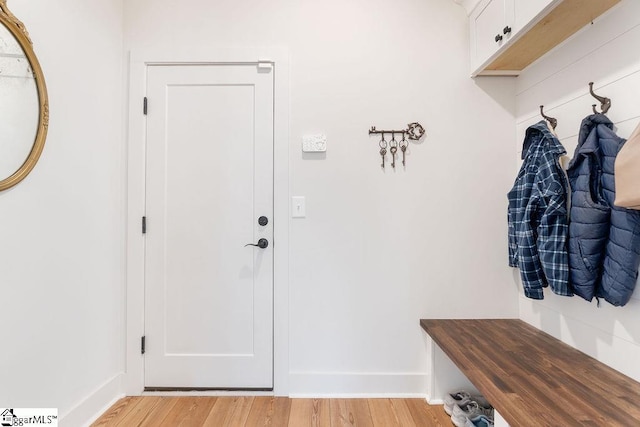 mudroom featuring light wood-type flooring and baseboards