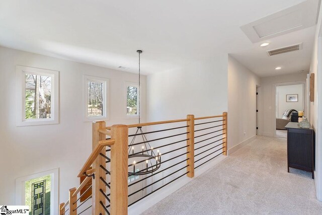 hall with visible vents, baseboards, an upstairs landing, carpet flooring, and recessed lighting