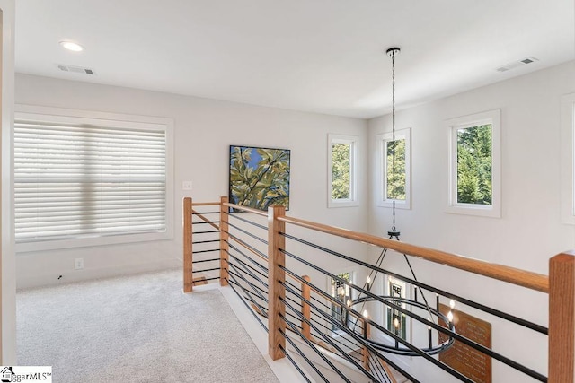 hallway with carpet, recessed lighting, an upstairs landing, and visible vents