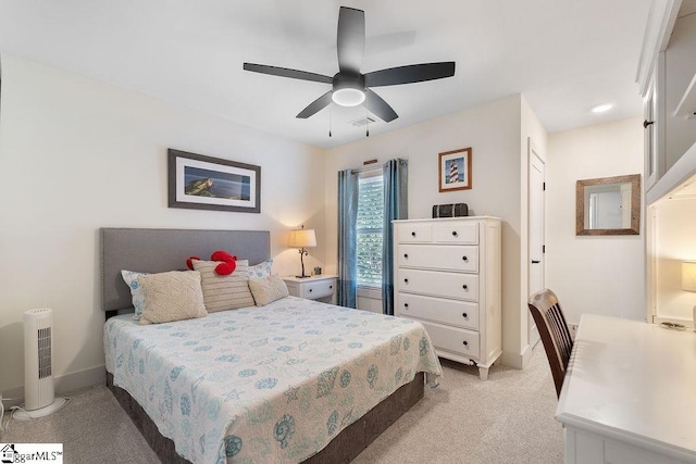 bedroom with visible vents, baseboards, light colored carpet, and a ceiling fan