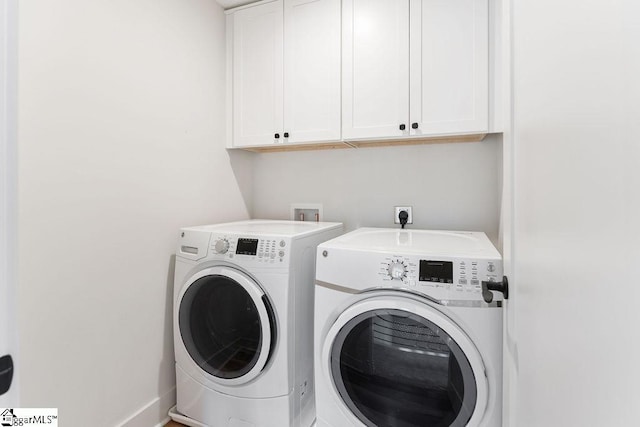 laundry area with washer and dryer and cabinet space