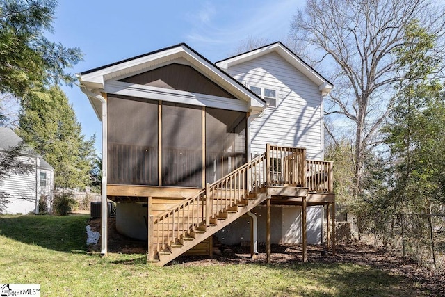 back of property with fence, a yard, central AC, a sunroom, and stairs