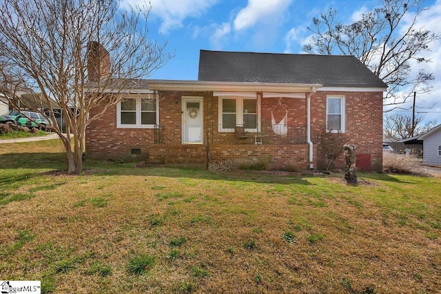 view of front of home featuring brick siding, crawl space, and a front lawn