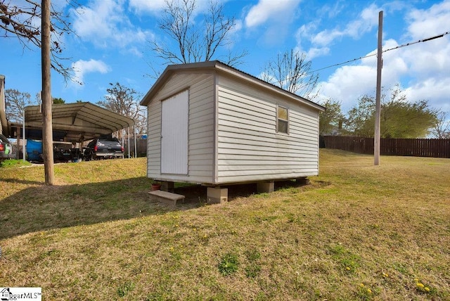 view of shed featuring a detached carport and fence