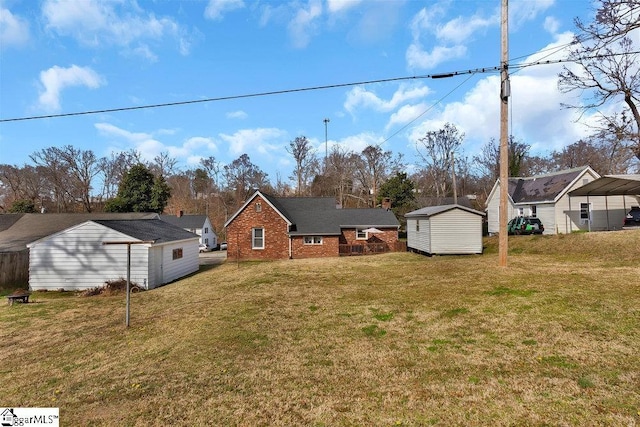 exterior space with an outbuilding, a storage unit, brick siding, and a yard