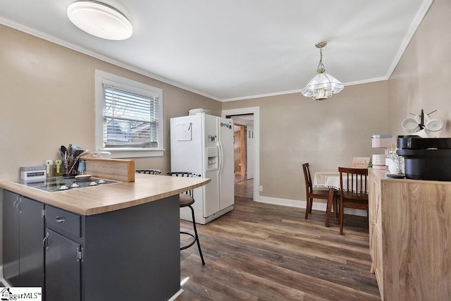 kitchen featuring electric stovetop, white fridge with ice dispenser, crown molding, baseboards, and dark wood-style flooring