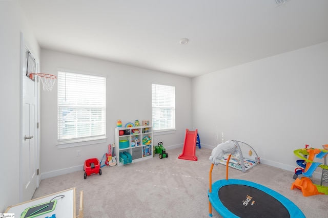 rec room featuring baseboards and carpet floors