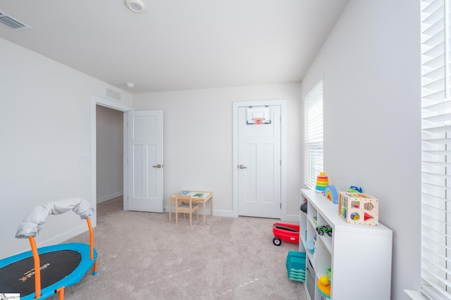 rec room with visible vents, carpet floors, and baseboards