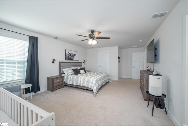 bedroom featuring light colored carpet, visible vents, and baseboards