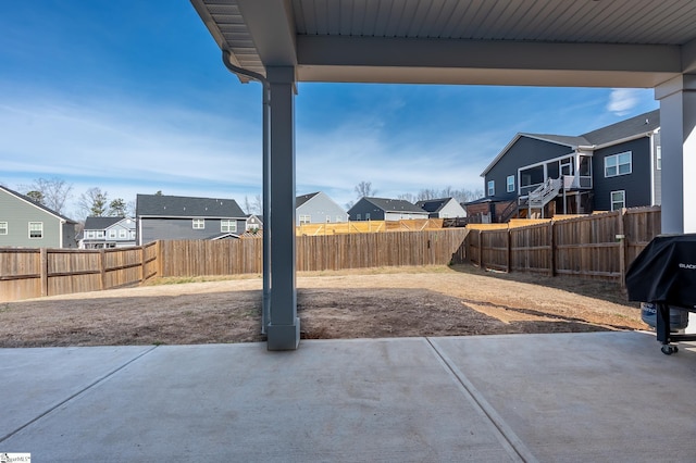 view of patio featuring a fenced backyard and a residential view