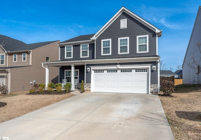 traditional-style home with stone siding, a porch, concrete driveway, and an attached garage