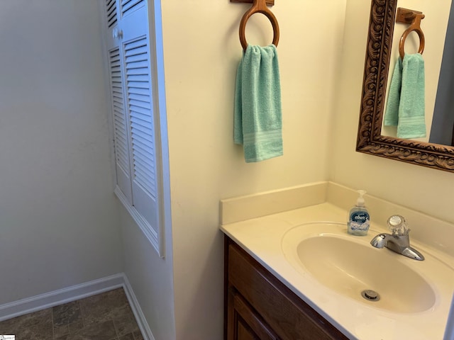 bathroom with vanity and baseboards